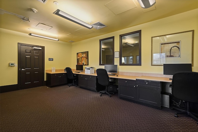 office area with dark colored carpet and built in desk