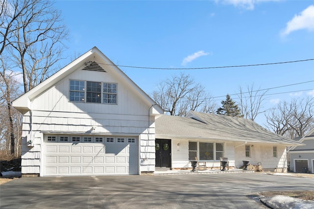 view of front facade with aphalt driveway and an attached garage