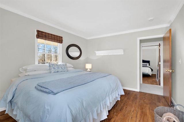 bedroom featuring ornamental molding, baseboards, and wood finished floors