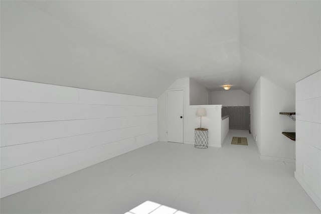 additional living space featuring lofted ceiling