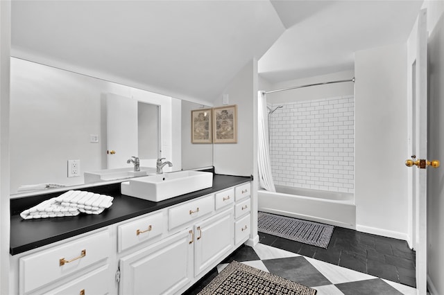 full bath featuring vaulted ceiling, vanity, and shower / bath combo with shower curtain