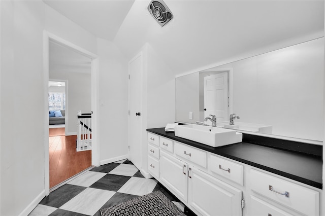 bathroom featuring baseboards, visible vents, and vanity