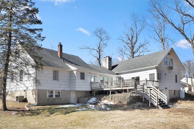 rear view of property featuring stairs, a yard, a chimney, and a wooden deck