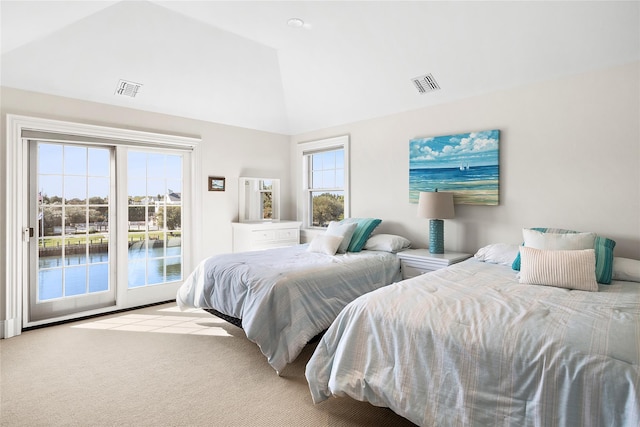 carpeted bedroom featuring lofted ceiling and access to outside