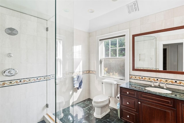 bathroom with vanity, a shower with shower door, and toilet