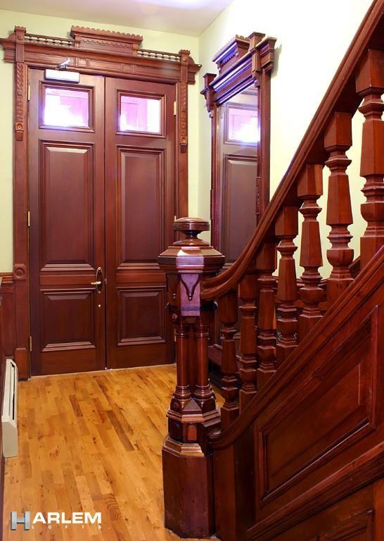 foyer with a baseboard radiator and light hardwood / wood-style flooring