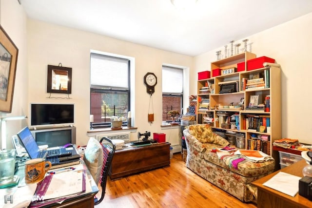 office featuring a baseboard radiator and hardwood / wood-style floors