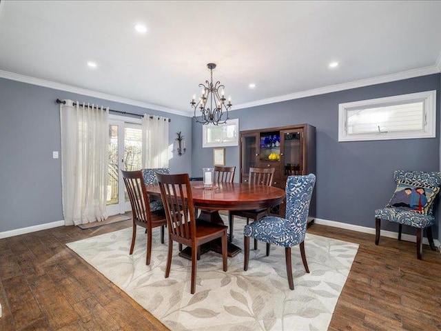 dining area with an inviting chandelier, ornamental molding, and dark hardwood / wood-style floors