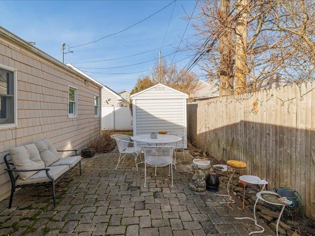 view of patio with a storage unit