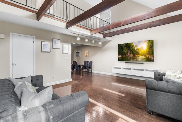 living room featuring hardwood / wood-style flooring, beam ceiling, and a high ceiling