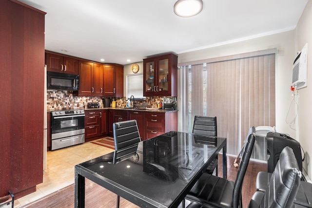 kitchen with light tile patterned flooring, stainless steel electric stove, sink, and backsplash