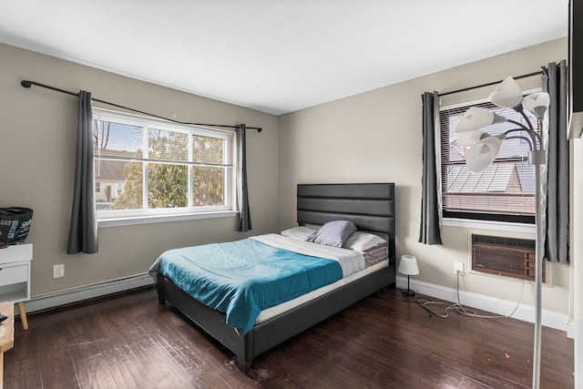 bedroom with cooling unit, dark wood-type flooring, and baseboard heating