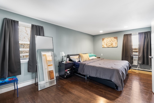 bedroom with dark hardwood / wood-style floors