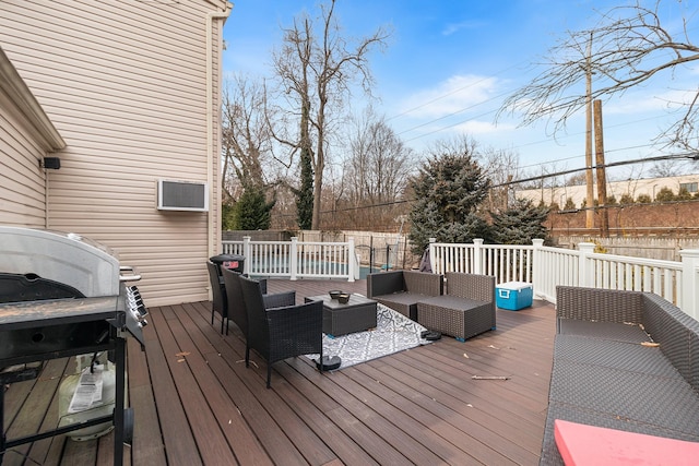 wooden deck with area for grilling and an outdoor hangout area