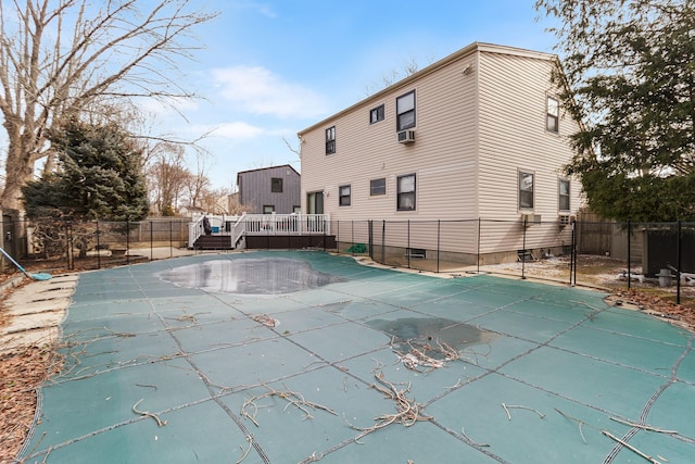 view of pool with cooling unit and a deck