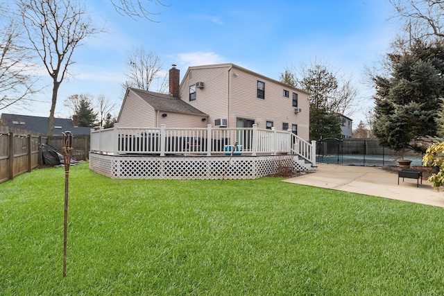 back of house with a yard, a patio, and a swimming pool side deck