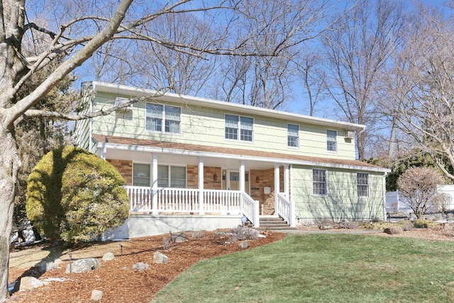 view of front of house featuring a porch and a front yard