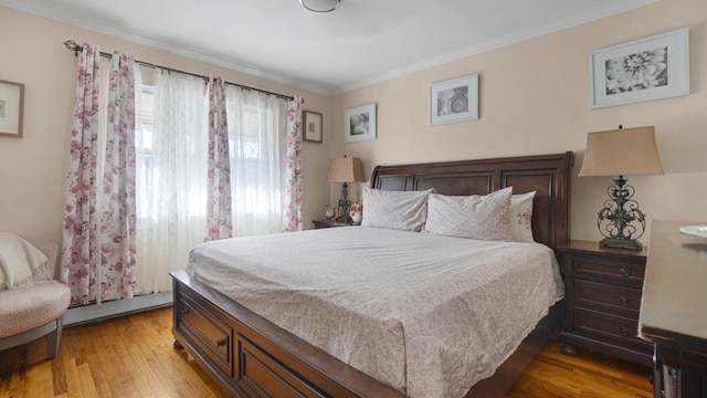 bedroom with light hardwood / wood-style flooring, a baseboard radiator, and ornamental molding