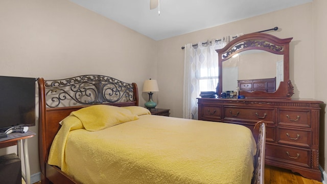 bedroom featuring hardwood / wood-style flooring, vaulted ceiling, and ceiling fan