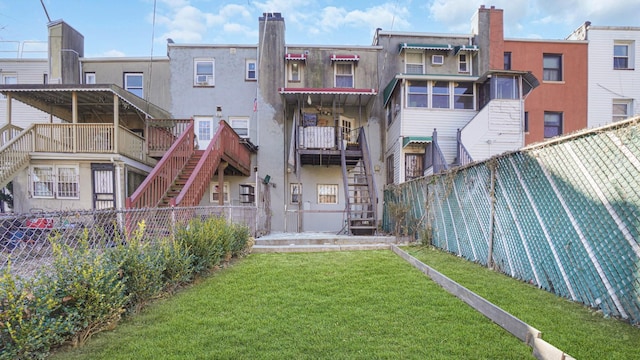 rear view of house with a yard