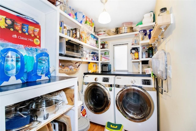 clothes washing area featuring washing machine and clothes dryer