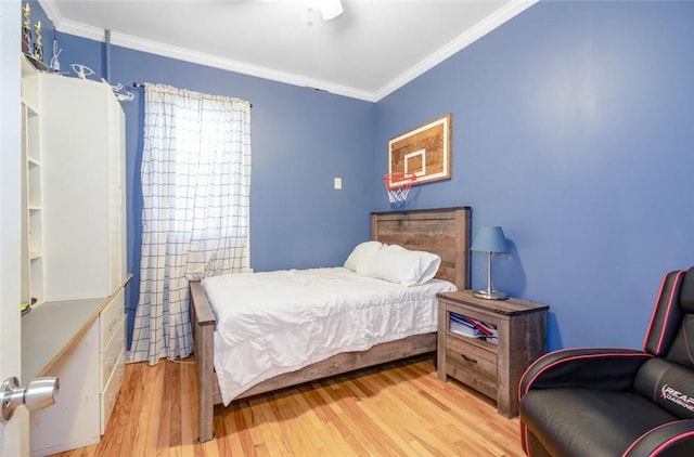 bedroom with crown molding and light wood-type flooring