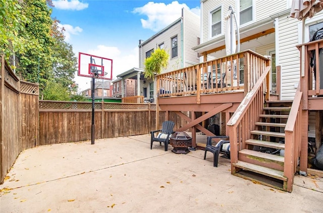 view of patio / terrace featuring a deck and a fire pit