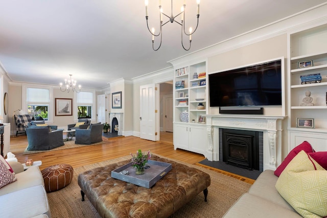 157 Merlin Ave, Sleepy Hollow, NY 10591 - living room with a chandelier, a fireplace with flush hearth, light wood-style flooring, ornamental molding, and built in shelves