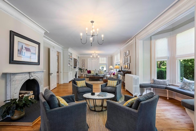 157 Merlin Ave, Sleepy Hollow, NY 10591 - living room with a chandelier, ornamental molding, a premium fireplace, and wood finished floors