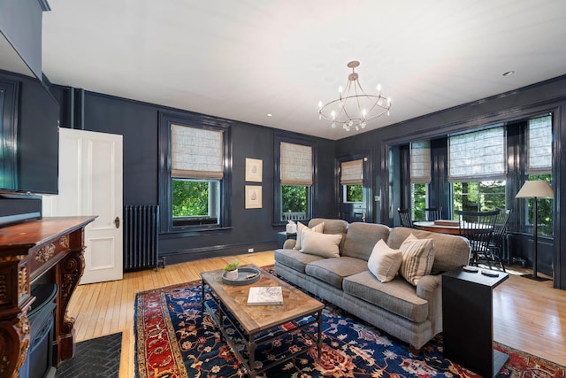 157 Merlin Ave, Sleepy Hollow, NY 10591 - living room featuring radiator, a chandelier, wood-type flooring, and a decorative wall