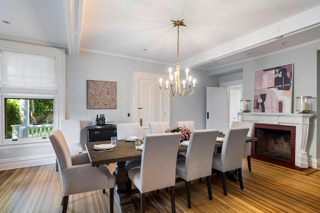 157 Merlin Ave, Sleepy Hollow, NY 10591 - dining space featuring a chandelier, wood finished floors, a fireplace, and crown molding