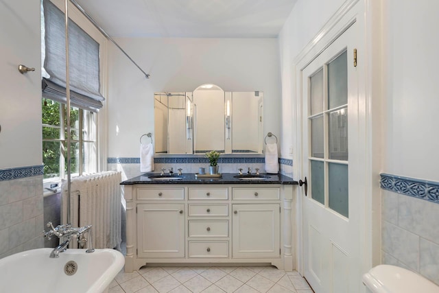 157 Merlin Ave, Sleepy Hollow, NY 10591 - bathroom featuring tile walls, a freestanding tub, tile patterned floors, double vanity, and wainscoting