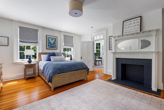 157 Merlin Ave, Sleepy Hollow, NY 10591 - bedroom featuring wood finished floors and a brick fireplace