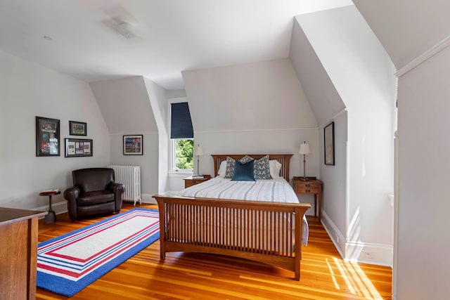 157 Merlin Ave, Sleepy Hollow, NY 10591 - bedroom featuring radiator, wood finished floors, and vaulted ceiling