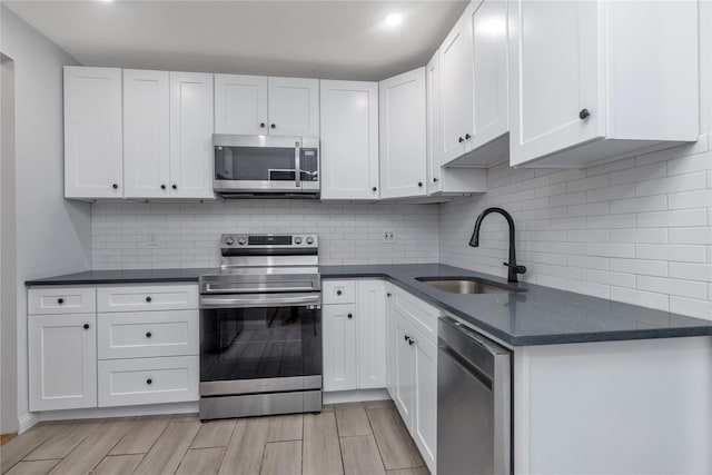 kitchen featuring sink, white cabinets, and appliances with stainless steel finishes