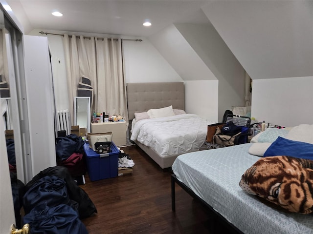 bedroom with lofted ceiling and dark hardwood / wood-style flooring