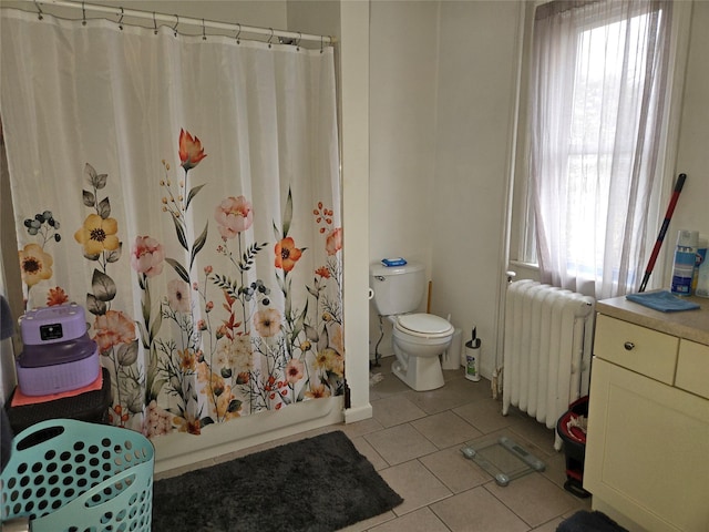 bathroom with shower / tub combo with curtain, toilet, radiator, and tile patterned flooring