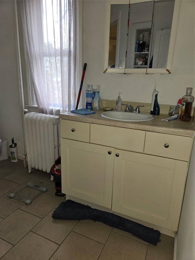 bathroom with vanity, radiator, and tile patterned flooring