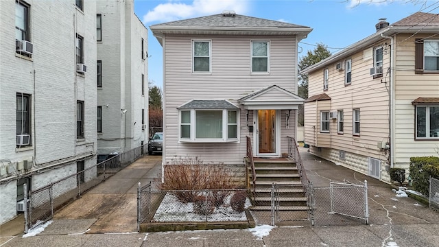 2850 Harrington Ave, Bronx, NY 10461 - view of front facade with fence, cooling unit, a gate, and roof with shingles