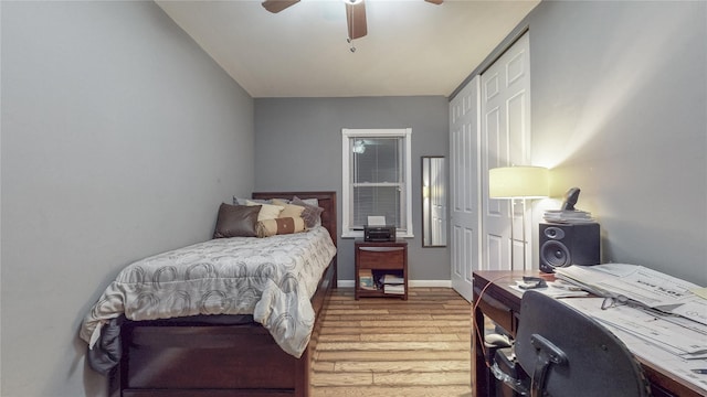 bedroom featuring light wood-style floors, ceiling fan, and baseboards