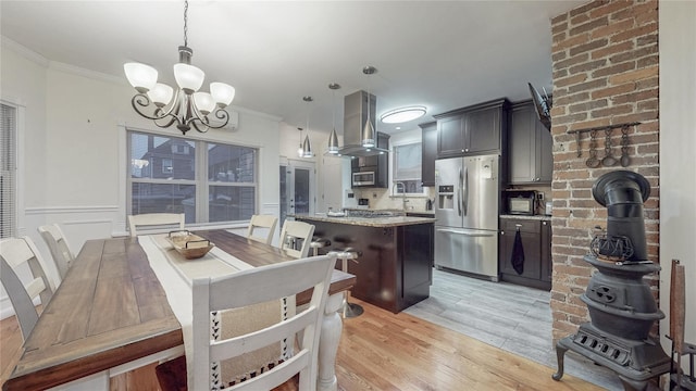 2850 Harrington Ave, Bronx, NY 10461 - kitchen with stainless steel appliances, island range hood, an inviting chandelier, and ornamental molding