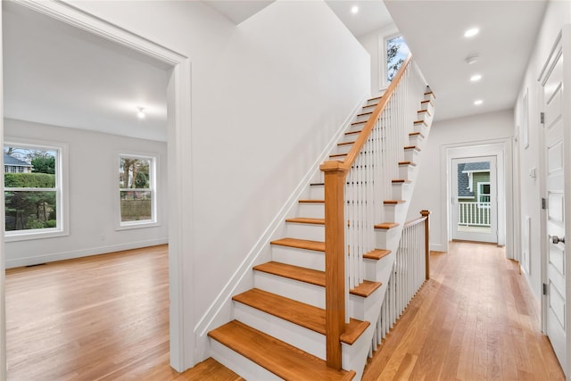 stairway with hardwood / wood-style floors