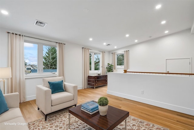 living room with light hardwood / wood-style flooring