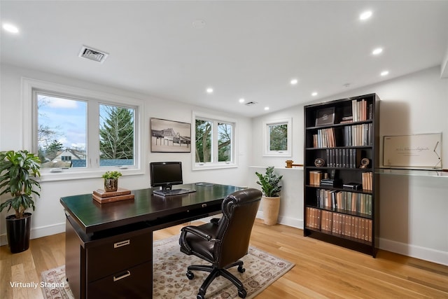 office area with vaulted ceiling and light hardwood / wood-style floors