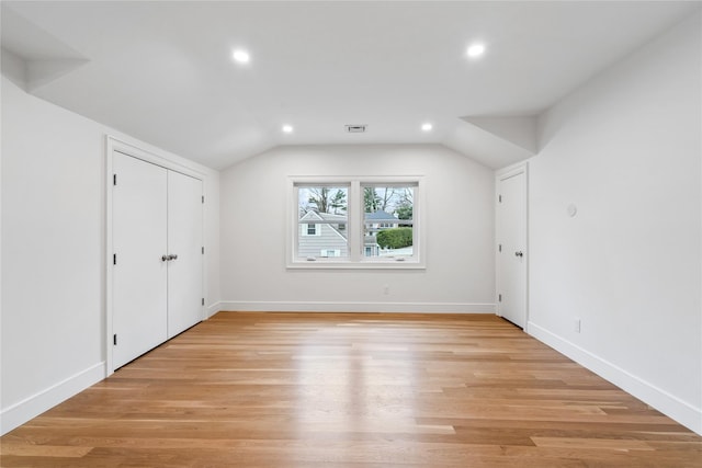 bonus room with light hardwood / wood-style flooring and vaulted ceiling