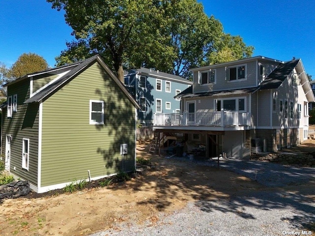 rear view of property featuring a deck