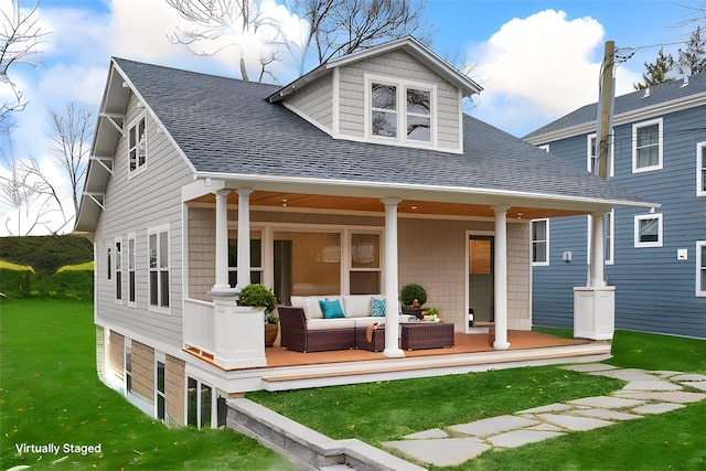 view of front of home featuring an outdoor living space, a porch, a front yard, and roof with shingles