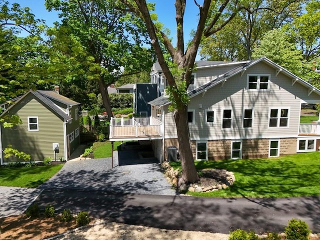 68 Glenlawn Ave, Sea Cliff, NY 11579 - view of front of property featuring asphalt driveway, a deck, a front lawn, and a carport