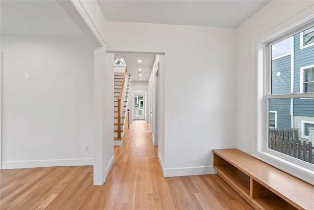 68 Glenlawn Ave, Sea Cliff, NY 11579 - hallway with light wood finished floors, plenty of natural light, stairway, and recessed lighting