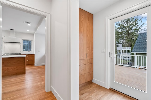 68 Glenlawn Ave, Sea Cliff, NY 11579 - doorway to outside featuring plenty of natural light, light wood-style floors, and an office area